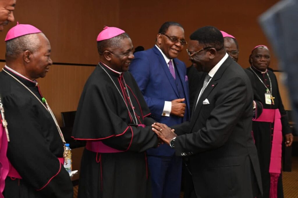 Minister of State Ferdinand Ngoh Ngoh greets the Archbishop of Bamenda, President of the Episcopal Conference of Cameroon, during an audience with Catholic leaders. Minister of State Ferdinand Ngoh Ngoh greets the Archbishop of Bamenda, President of the Episcopal Conference of Cameroon, during an audience with Catholic leaders.